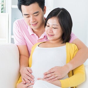 A husband comforting a pregnant mother experiencing pregnancy fatigue A husband comforting a pregnant mother experiencing pregnancy fatigue