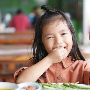 a girl happily eating food